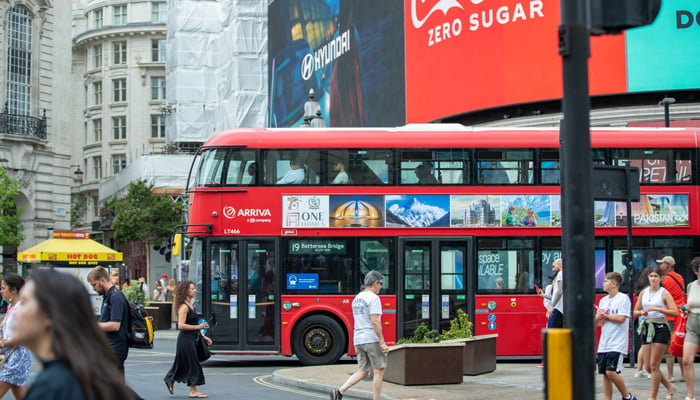 A red bus with the banner of the campaign regarding Pakistans 75th Independence Day in London. — Photo by author