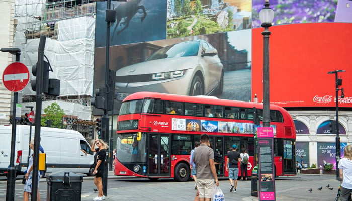 A red bus with the banner of the campaign regarding Pakistans 75th Independence Day in London. — Photo by author