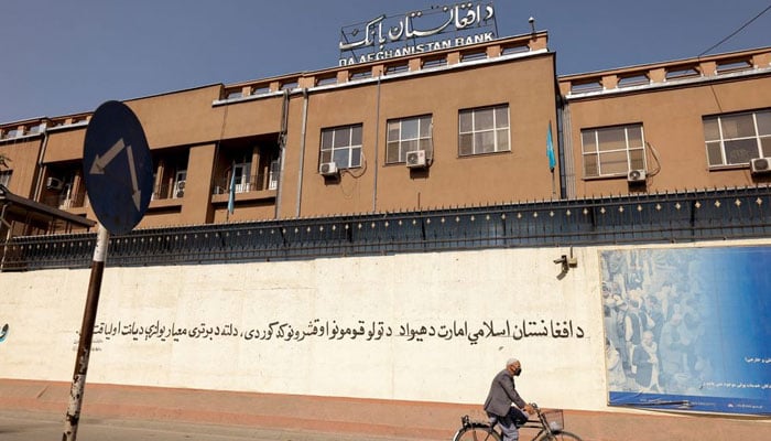 A man rides a bike in front of the Bank of Afghanistan in Kabul, Afghanistan October 8, 2021. &mdash; Reuters/File