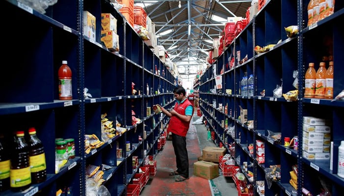 An employee scans a package for an order at a BigBasket warehouse on the outskirts of Mumbai, on November 4, 2014. — Reuters