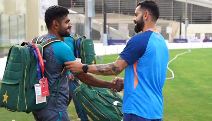 Pakistan all-format skipper Babar Azam (L) shakes hands with Indian batter Virat Kohli at Dubai International Stadium ahead of the Asia Cup 2022. — Twitter screengrab/@BCCI