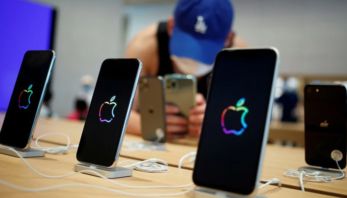 A man takes pictures of iPhones in the new Apple flagship store on its opening day following an outbreak of the coronavirus disease (COVID-19) in Sanlitun in Beijing, China, July 17, 2020. — Reuters