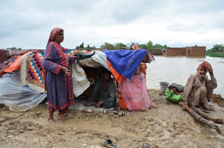 A family takes refuge on a higher ground following rains and floods during the monsoon season in Dera Allah Yar, district Jafferabad, Balochistan, Pakistan, August 25. — Reuters