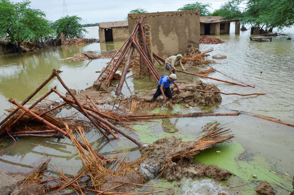 People retrieve bamboos from a damaged house following rains and floods during the monsoon season in Dera Allah Yar, district Jafferabad, Balochistan, Pakistan August 25, 2022.  — Reuters