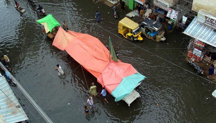 A view of rain water still inundated on roads and houses in the latifabad 11 area. — Online