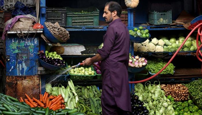 A vendor waters the vegetables at a stall in Islamabad, Pakistan July 4, 2019. — Reuters/File