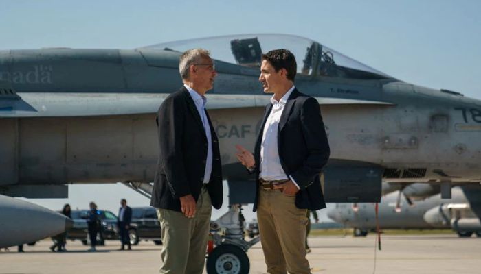 Canadas Prime Minister Justin Trudeau speaks with NATO Secretary General Jens Stoltenberg near a Canadian Forces CF-18 Hornet fighter aircraft during their visit to CFB Cold Lake in Cold Lake, Alberta, Canada August 26, 2022. — Reuters