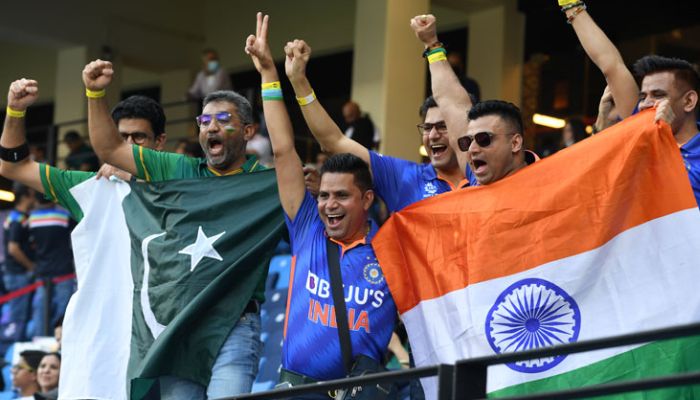 Fans of Pakistans and Indian cricket teams cheer before the start of match. — AFP