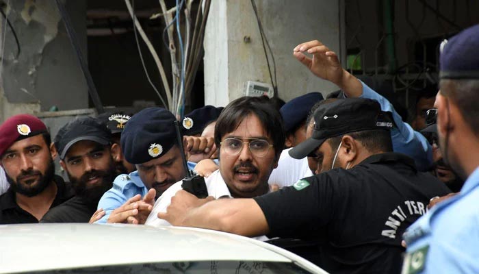 Police officers escort the leader of Pakistan Tehreek-e-Insaaf (PTI) Doctor Shahbaz Gill after a hearing at district court, in Federal Capital. — Online