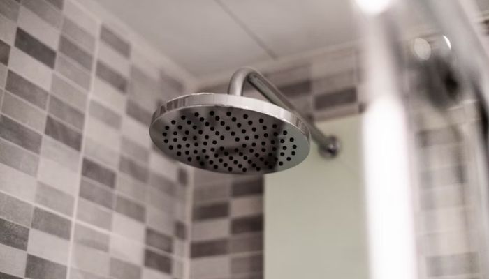 A grey showerhead. — Unsplash