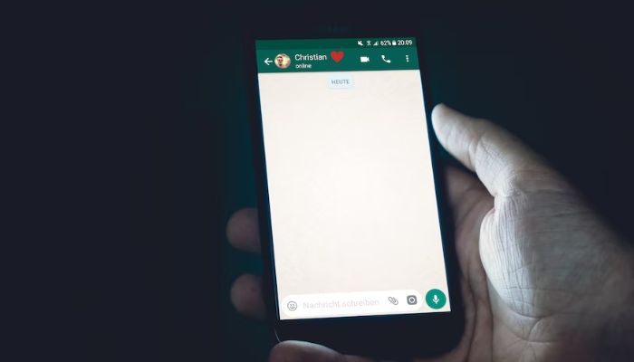 A person using WhatsApp. — Unsplash
