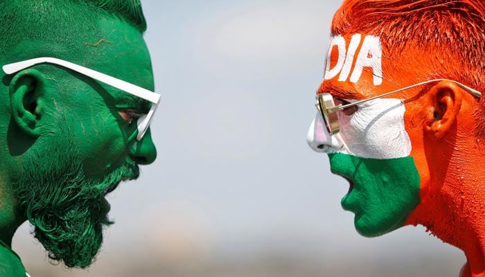 Cricket fans, with their faces painted in the Indian and Pakistani national flag colours, pose for a picture ahead of the first match between India and Pakistan in Twenty20 World Cup super 12 stages in Dubai, in Ahmedabad, India, October 23, 2021.— Reuters/File