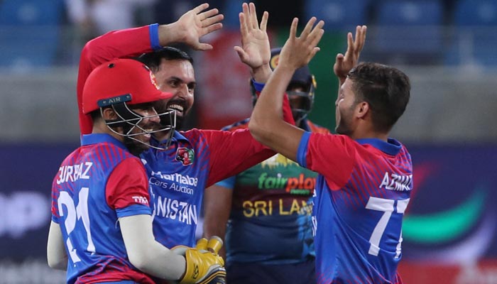 Afghanistan´s captain Mohammad Nabi (C) celebrates after dismissing Sri Lanka´s captain Dasun Shanaka (not pictured) during the Asia Cup Twenty20 International cricket Group B match between Sri Lanka and Afghanistan at the Dubai International Cricket Stadium in Dubai on August 27, 2022. — AFP