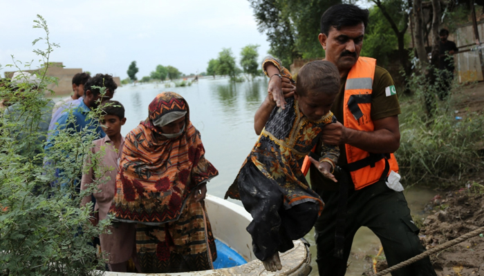 Residents are evacuated from a flood-affected area of Rajanpur, Punjab province. — Shahid Saeed Mirza/AFP