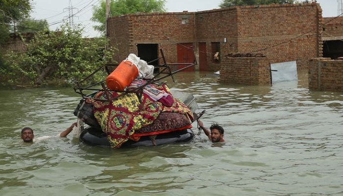 Residents move their belongings from sunken houses in Rajanpur district, Punjab province, after heavy monsoon rainfall on August 24, 2022. — AFP