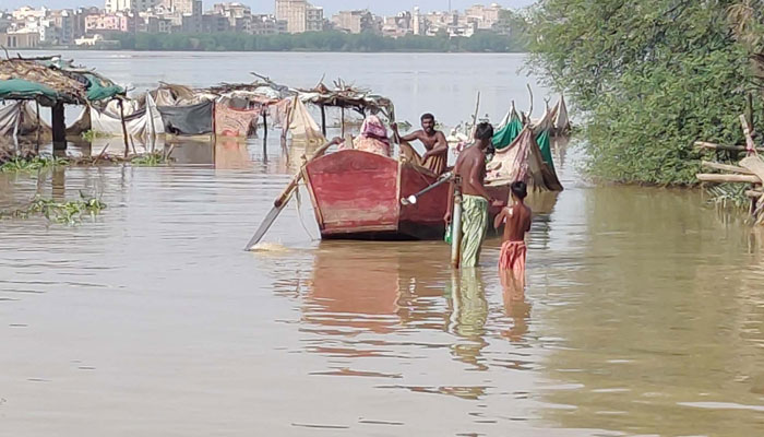 People are using boats for transportation after floodwater spread over thousands of acres of land in Sukkur on August 29, 2022. PPI