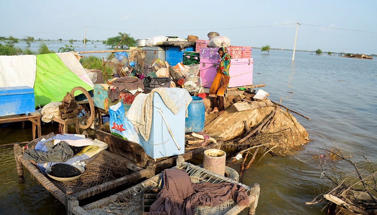 A woman is seen with her belongings, as her family took refuge on a higher ground following rains and floods during the monsoon season in Sohbatpur, Pakistan August 28, 2022. — Reuters