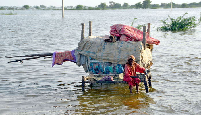 An old woman waiting for aid on the National Highway in Sohbatpur on August 29, 2022. ONLINE