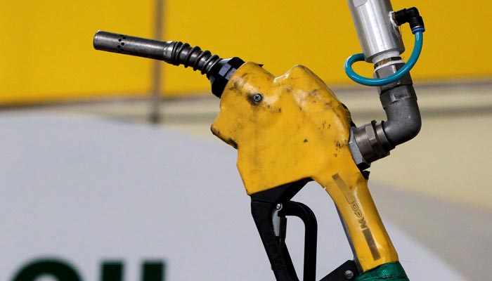 A gas pump is seen hanging from the ceiling at a petrol station. — Reuters/File