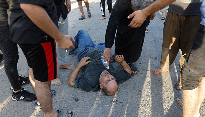 An injured supporter of Iraqi populist leader Moqtada al-Sadr is given water amidst a protest at the Green Zone, in Baghdad, Iraq August 29, 2022. — Reuters