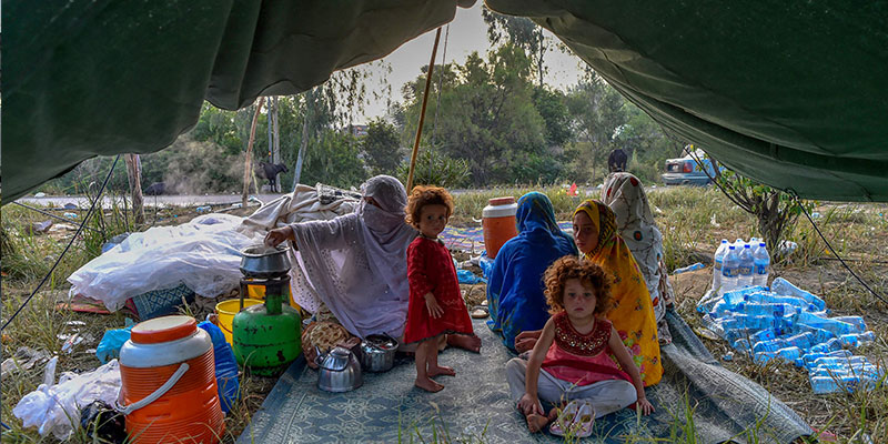 Displaced people prepare for breakfast in their tents at a makeshift camp after fleeing from their flood hit homes following heavy monsoon rains in Charsadda district of Khyber Pakhtunkhwa on August 29, 2022. — AFP