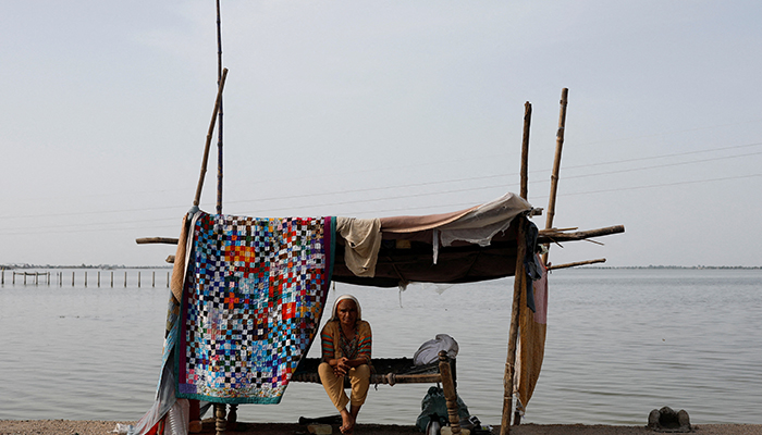 A flood victim takes refuge along a road in a makeshift tent, following rains and floods during the monsoon season in Mehar, Pakistan August 29, 2022. — Reuters