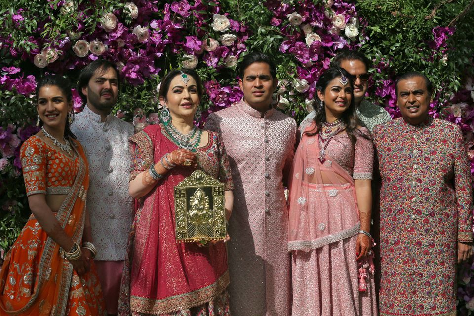 (L-R) Radhika Merchant, Anant Ambani, Nita Ambani, Akash Ambani, Isha Piramal, Anand Piramal and Mukesh Ambani, the Chairman of Reliance Industries, pose during a photo opportunity at the wedding ceremony of Akash, at Bandra-Kurla Complex in Mumbai, India, March 9, 2019. — Reuters