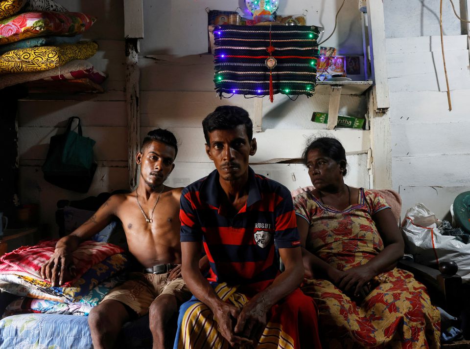 Gamage Rupawathi (R), 60, her husband W. A. Susantha (C), 45, and their son, Krishan Darshana (L), 25, pose at their home, amid the countrys economic crisis, in Colombo, Sri Lanka, August 2, 2022. When I had a fruit business I was earning a significant income, Rupawathi said. But with the drawn-out lockdowns during the pandemic and now this economic crisis I dont have money to restart my fruit stall. — Reuters