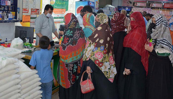 A large number of people standing in queue to purchase food items at Utility Store on subsidise rates by the government across the province. β APP/File