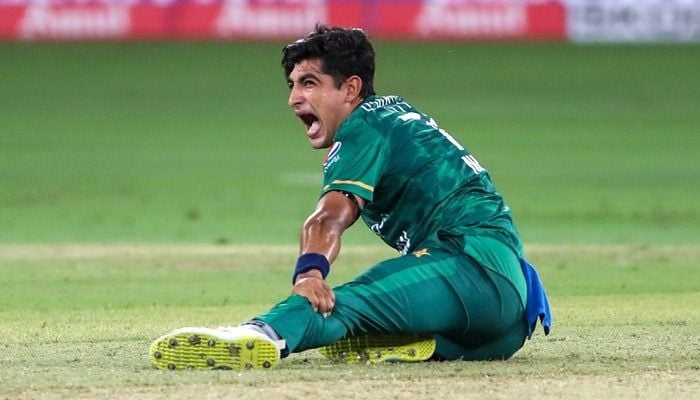 Pakistans Naseem Shah screams in pain holding his leg after delivering a ball during the Asia Cup Twenty20 international cricket Group A match between India and Pakistan at the Dubai International Cricket Stadium in Dubai on August 28, 2022. Photo: AFP