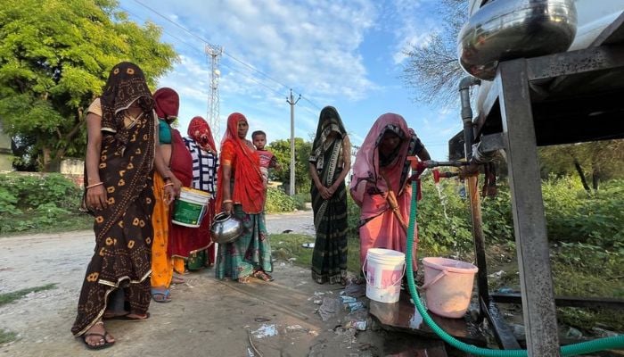 Women collect water from a public water tank in Karansar village in the Indian desert state of Rajasthan, India, August 26, 2022. — Reuters