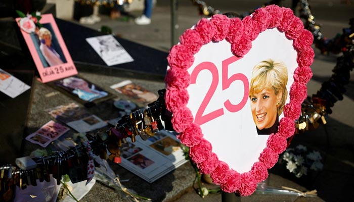 Pictures and flowers are left in memory of the late Princess Diana around the Liberty Flame monument above the tunnel of the Alma bridge where Diana Princess of Wales died in a car accident on August 31, 1997, in Paris, France, August 31, 2022. — Reuters
