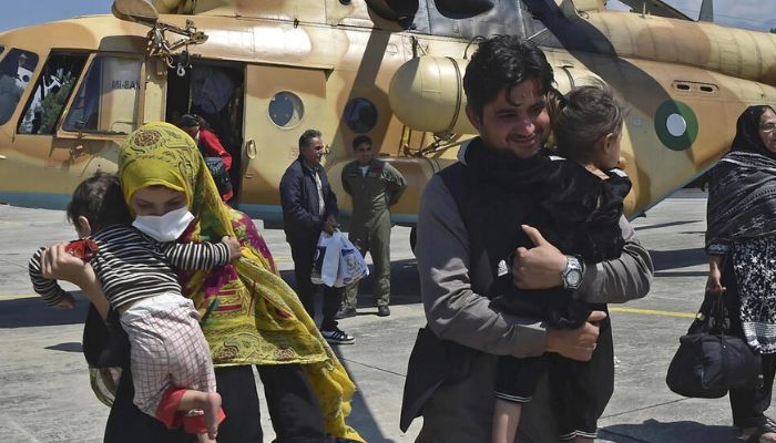 Local tourists disembark from a Pakistani army helicopter after they were rescued from flood-hit tourist areas in the north. — AFP