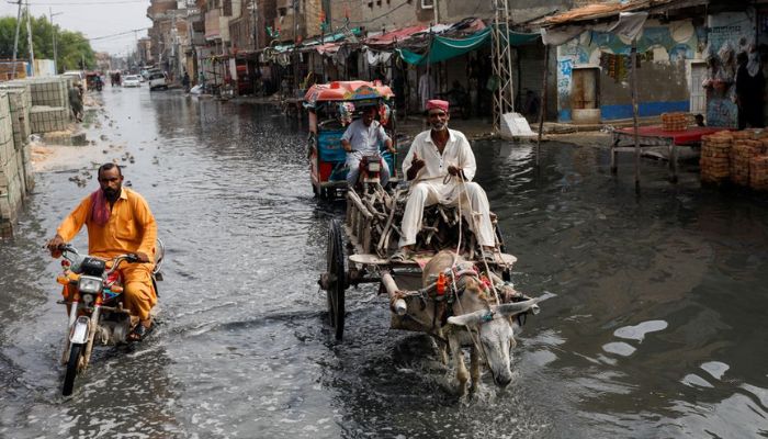 A man rides on donkey cart through rain waters, following rains and floods during the monsoon season in Jacobabad, Pakistan August 30, 2022. — Reuters