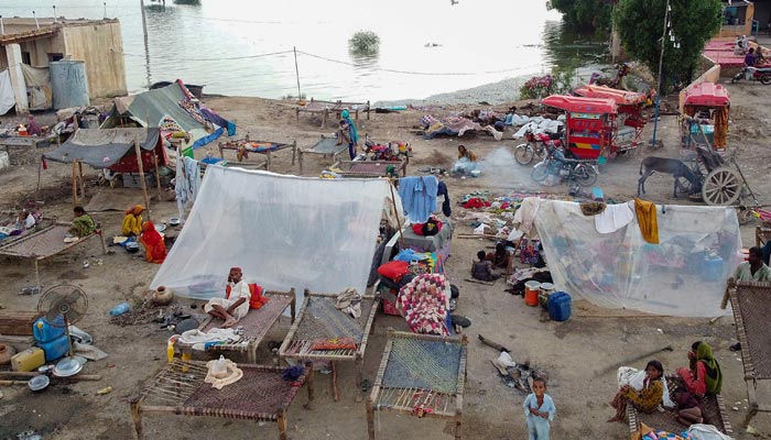 This aerial photograph taken on September 1, 2022, shows flood-affected people taking refuge in tents after heavy monsoon rains in Dera Allah Yar town of Jaffarabad district, Balochistan province. — AFP