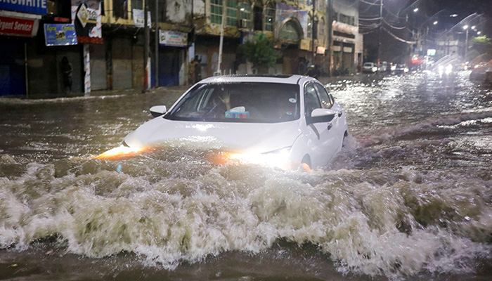 A vehicle drives along a flooded street, following heavy rains during the monsoon season in Karachi, Pakistan July 24, 2022. — Reuters