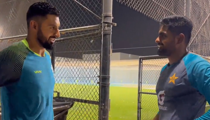 Hong Kong captain Nizakat Khan (left) speaks to Pakistan skipper Babar Azam in the United Arab Emirates, on September 1, 2022. — Twitter/PCB