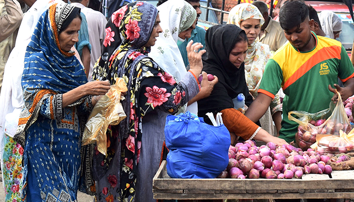 Women purchase onions at a vegetable Market in Lahore, Punjab, on August 31, 2022. — Online