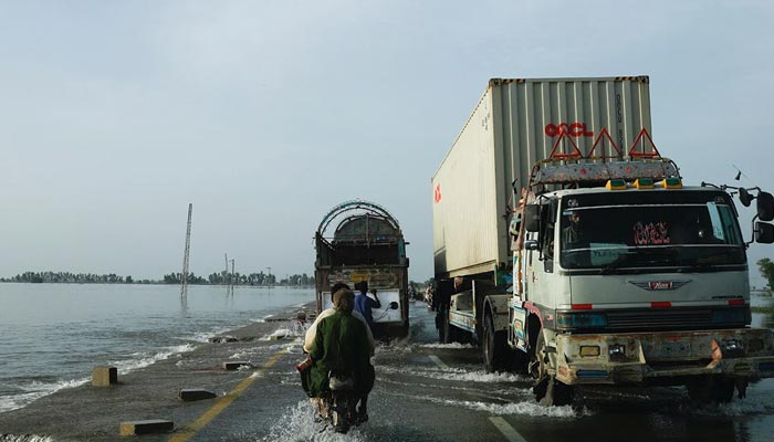 Vehicles move along a flooded road, following rains and floods during the monsoon season in Mehar, Pakistan August 29, 2022. — Reuters