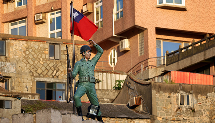 A Taiwan flag flutters behind a soldier statue on Dongyin island of Matsu archipelago in Taiwan August 15, 2022. — Reuters