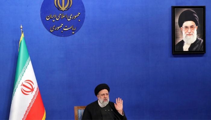 Iranian President Ebrahim Raisi sits near a portrait of Irans Supreme Leader Ayatollah Ali Khamenei as he speaks during a press conference in Tehran on August 29, 2022. — AFP