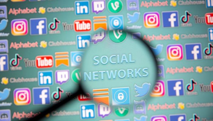 Social network words and social media logos are seen through magnifier displayed in this illustration taken, May 25, 2021. Picture taken May 25, 2021. — Reuters