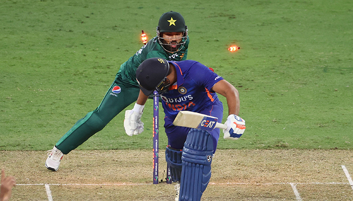 Pakistans wicketkeeper Mohammad Rizwan (back) unsuccessfully tries to dismiss Indias captain Rohit Sharma during the Asia Cup Twenty20 international cricket Group A match between India and Pakistan at the Dubai International Cricket Stadium in Dubai on August 28, 2022. — AFP