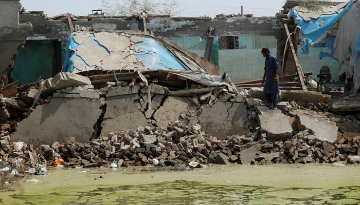 A man surveys the damage caused to his house following rains and floods during the monsoon season, in Charsadda, Pakistan September 3, 2022. — Reuters