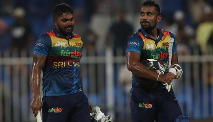 Sri Lanka´s Chamika Karunaratne (R) and Wanindu Hasaranga leave the field after winning the Asia Cup Twenty20 international cricket match between Sri Lanka and Afghanistan at the Sharjah Cricket Stadium in Sharjah on September 3, 2022. — AFP/File