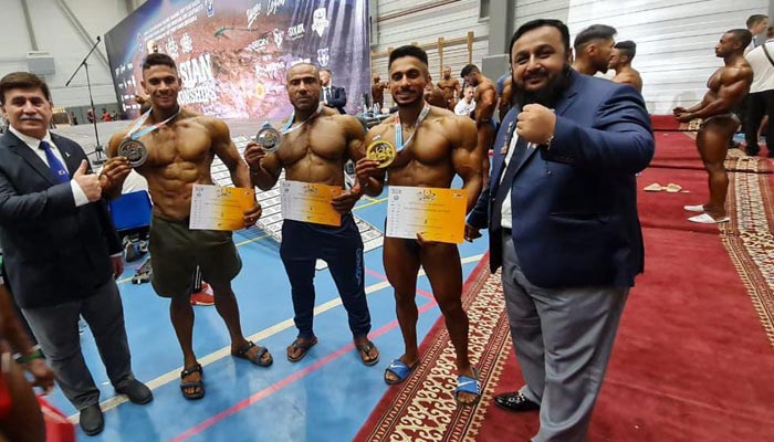 Pakistani bodybuilders pose for a picture with their silver and bronze medals on the first day of the Asian Bodybuilding Championship. — Geo Super