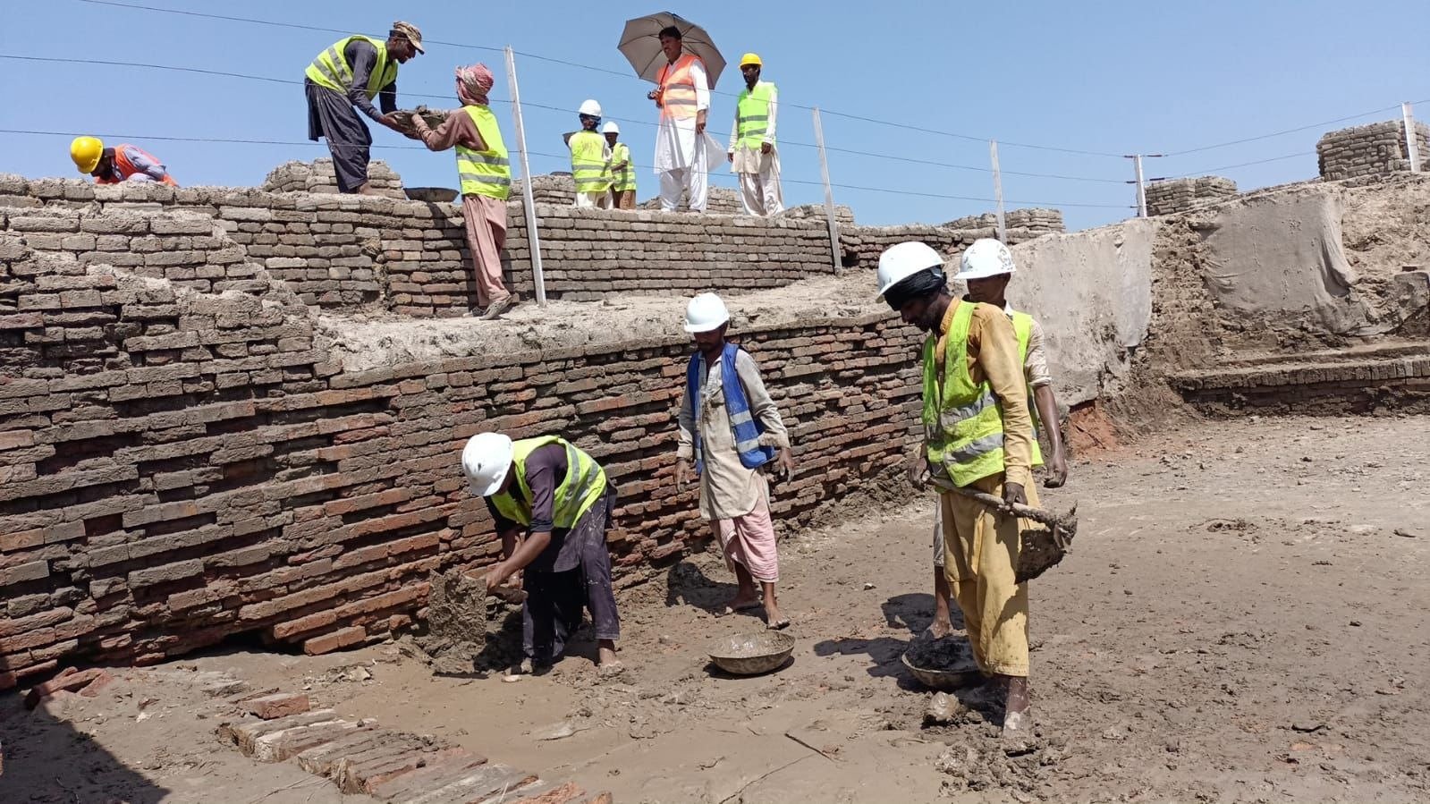 Workers doing patch work in between the iconic baked bricks dating back to the beginning of the 3rd millennium BC. — Photo by author