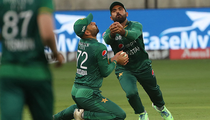 Pakistans Khushdil Shah (#72) collides with his teammate Fakhar Zaman (R) before taking a catch to dismiss Indias captain Rohit Sharma (not pictured) during the Asia Cup Twenty20 international cricket Super Four match between India and Pakistan at the Dubai International Cricket Stadium in Dubai on September 4, 2022. — AFP