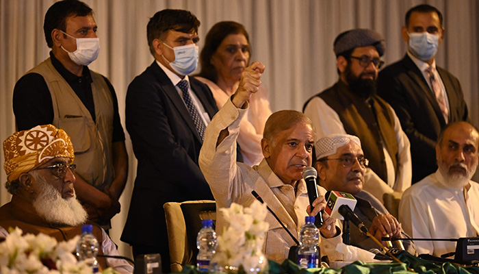 Prime Minister Shehbaz Sharif (centre) and PPP Co-chairman Asif Ali Zardari (second right) speak during a press conference in Islamabad on March 28, 2022. — AFP