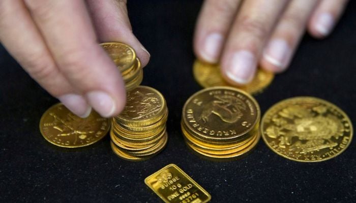 A worker places gold bullion on display at Hatton Garden Metals precious metal dealers in London, Britain July 21, 2015. — Reuters